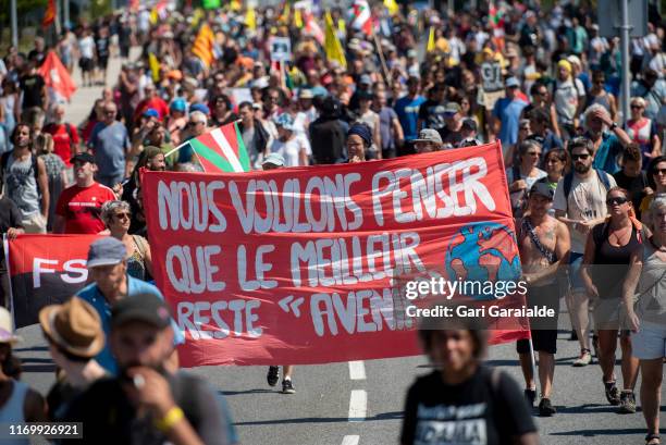 Protesters march to protest against the annual G7 Summit, 30 kilometres south of the G7 gathering in Biarritz, on August 24, 2019 in Hendaye, France....