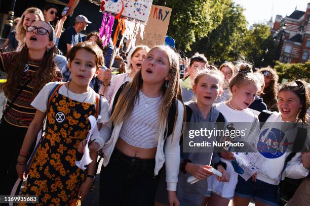 Demonstrators chant and shout on Abingdon Street outside the Houses of Parliament as environmentalists tens of thousands strong take part in the...