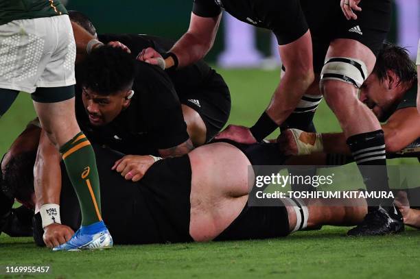 New Zealand's lock Samuel Whitelock has his shorts pulled during the Japan 2019 Rugby World Cup Pool B match between New Zealand and South Africa at...