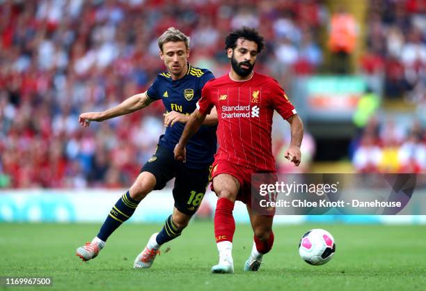 Mohamed Salah of Liverpool is challenged by Nacho Monreal of Arsenal during the Premier League match between Liverpool FC and Arsenal FC at Anfield...