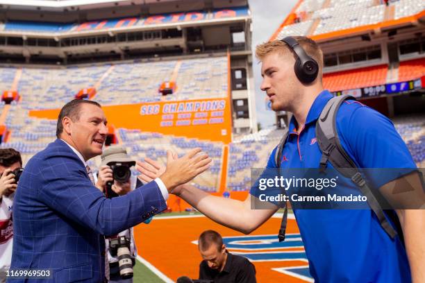 Head coach Dan Mullen greets Kyle Trask of the Florida Gators prior to the game vs the Tennessee Volunteers at Ben Hill Griffin Stadium on September...