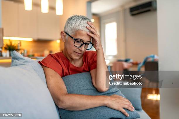 stressed senior woman at home - older widow stock pictures, royalty-free photos & images