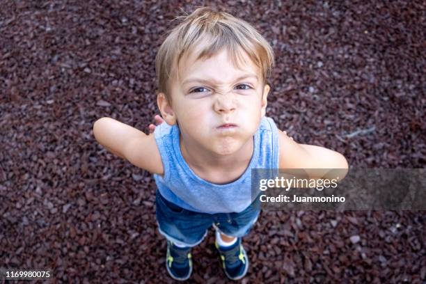 very upset little child boy looking at the camera - mal imagens e fotografias de stock