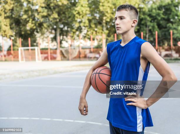 basketball player with a cool attitude - teenagers only stock pictures, royalty-free photos & images