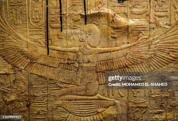 This picture taken on September 21, 2019 shows a view of reliefs on the foot of the golden sarcophagus of the ancient Egyptian Pharaoh Tutankhamun as...