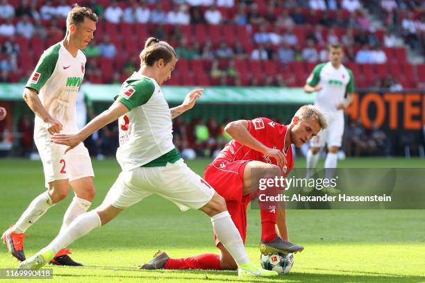 Sebastian Andersson of Union Berlin battles for the ball with Tim Jedvaj of Augsburg and his team mate Stephan Lichtsteiner during the Bundesliga...