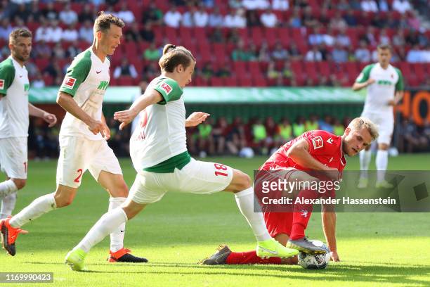 Sebastian Andersson of Union Berlin battles for the ball with Tim Jedvaj of Augsburg and his team mate Stephan Lichtsteiner during the Bundesliga...