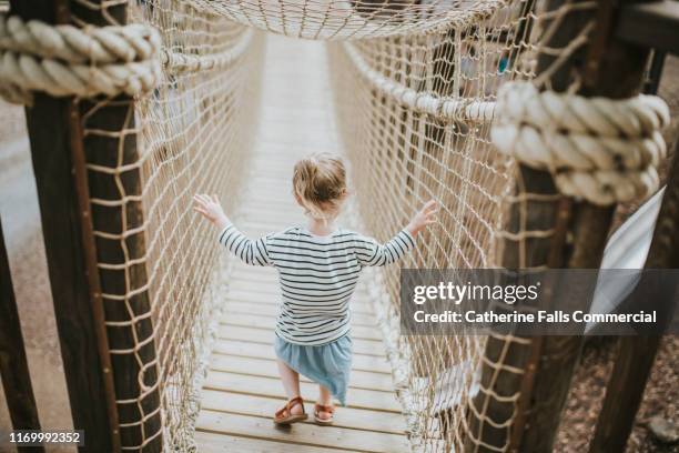 Step Onto Rope Bridge 53 Young Girl Walking Across Single Rope Bridge Stock Photos, High-Res ...