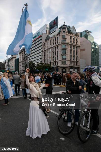 Woman holds an Argentinian flag during a march in support of President Mauricio Macri on August 24, 2019 in Buenos Aires, Argentina.