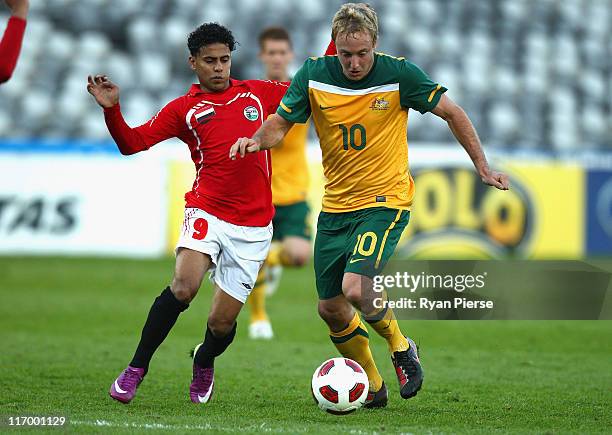 Mitchell Nichols of Australia is tackled by Mahammad Al Khader Alanbri of Yemen during the first 2012 London Olympic Games Asian Qualifier match...