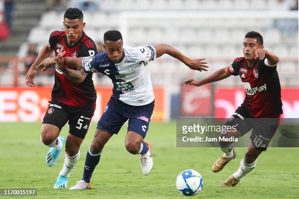 Jonathan Copete of Pachuca fights for the ball with Anderson Santamaria and Osvaldo Martinez of Atlas during the 6th round match between Pachuca and...