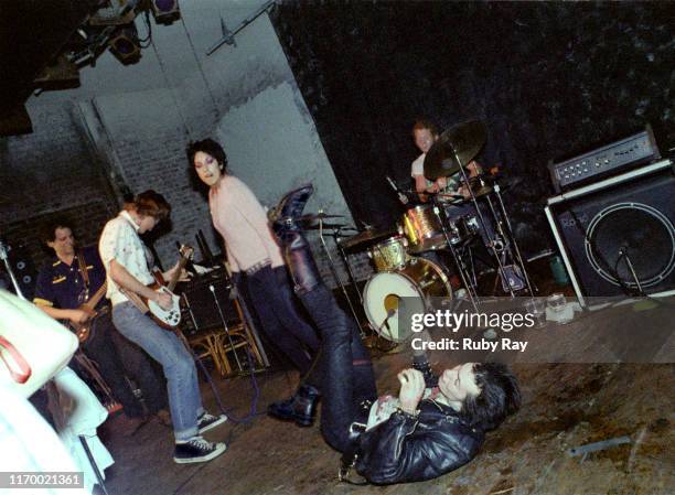 British musician Sid Vicious , the day after the Sex Pistols had split up, rolls on the stage floor mocking Los Angeles punk band Bags as they play...
