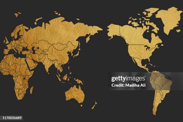 a world map in premium brass | gold | golden | copper color over black background - international art fair for contemporary objects stock pictures, royalty-free photos & images