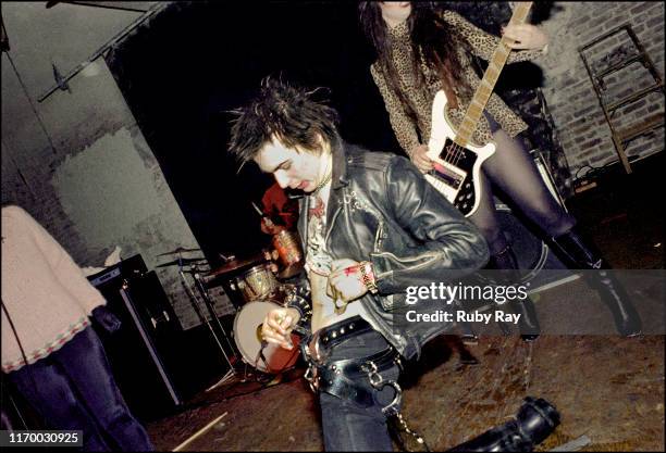 British musician Sid Vicious , the day after the Sex Pistols had split up, cutting his stomach on stage as Los Angeles punk band Bags play Mabuhay...