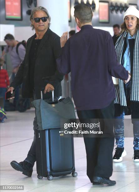 Jon Stevens and Heloise Pratt are seen departing Perth Airport on August 25, 2019 in Perth, Australia.