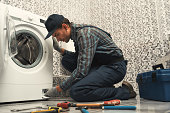 High quality workmanship. Plumber repairing washing machine