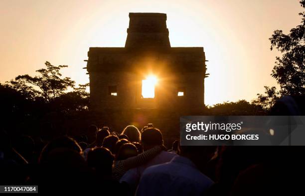 The sun is seen through the door of the Seven Dolls Temple, in the Maya archaeological site of Dzibilchaltun, in Yucatan State, Mexico, as it rises...