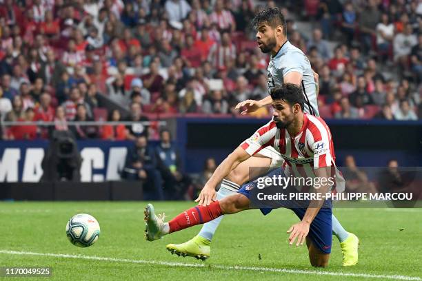 Atletico Madrid's Spanish forward Diego Costa vies with Celta Vigo's Mexican defender Nestor Araujo during the Spanish league football match between...