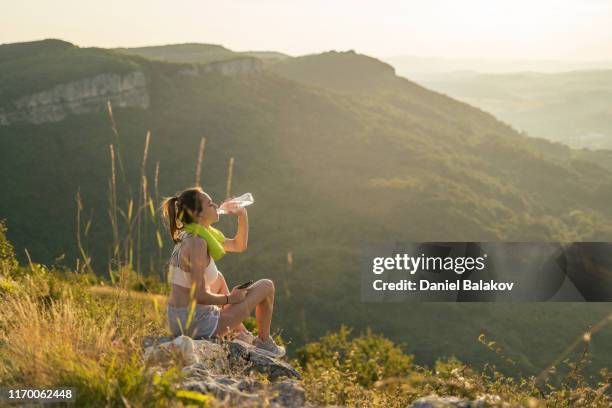 teen spirit. beautiful teenage girl taking a break after training outdoors in the nature. - drinking water outside stock pictures, royalty-free photos & images