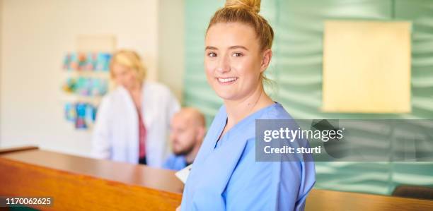 young female nurse portrait - nurse recruitment stock pictures, royalty-free photos & images