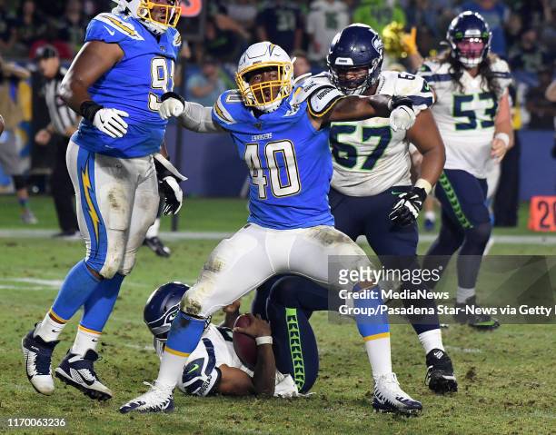 Linebacker Chris Peace of the Los Angeles Chargers reacts after sacking quarterback Geno Smith of the Seattle Seahawks in the second half of a...