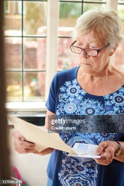 letter for senior woman - elderly receiving paperwork stock pictures, royalty-free photos & images