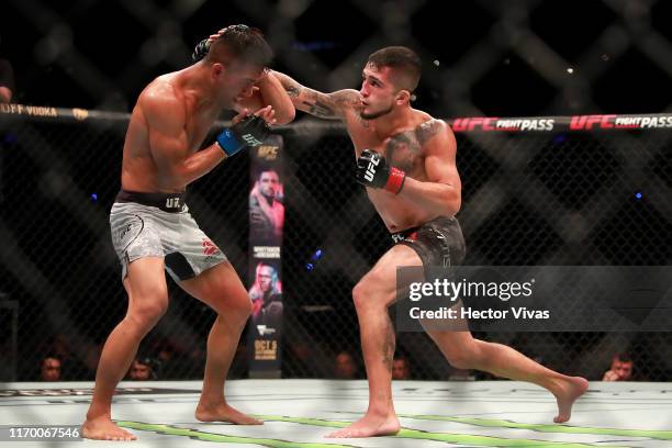 Sergio Pettis punches Tyson Nam in their flyweight bout during UFC Fight Night event at Arena Ciudad de Mexico on September 21, 2019 in Mexico City,...