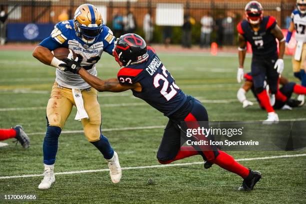 Montreal Alouettes Defensive back Tommie Campbell tackles Winnipeg Blue Bombers Running back Andrew Harris during the Winnipeg Blue Bombers versus...