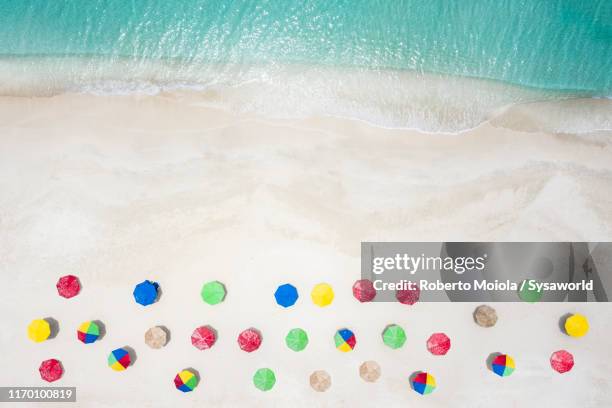 beach umbrellas from above, caribbean, antilles - strandschirm stock-fotos und bilder