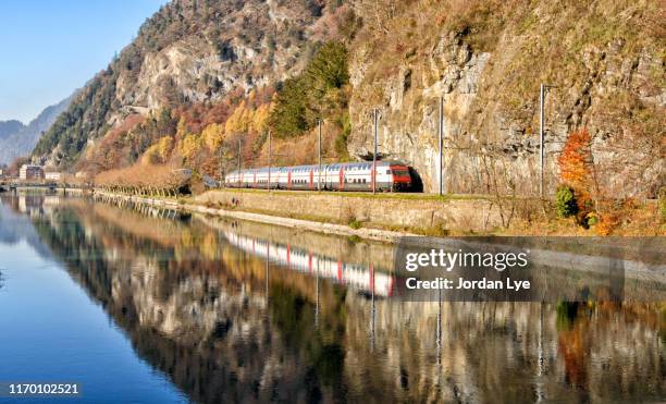 swiss train with lake reflection - subway train stock pictures, royalty-free photos & images