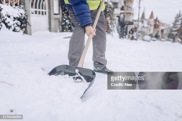 man cleaning snow on the street - absence stock pictures, royalty-free photos & images