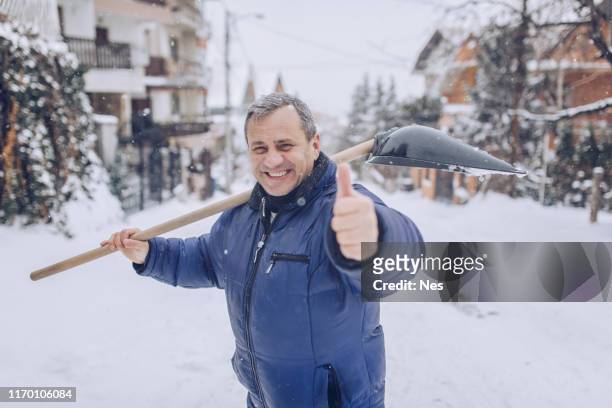 man cleaning snow on the street - shoveling driveway stock pictures, royalty-free photos & images