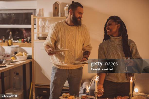 friendly winter dinner at home - couple arranging table stock pictures, royalty-free photos & images