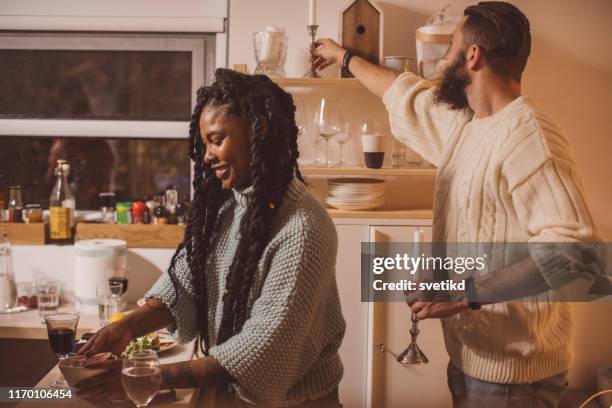 friendly winter dinner at home - couple arranging table stock pictures, royalty-free photos & images