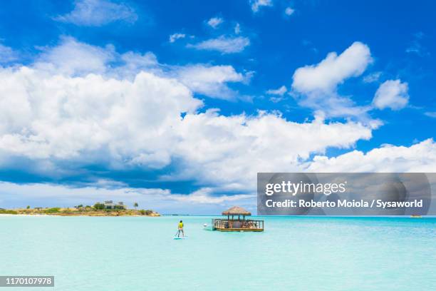 man paddleboarding to the ocean bar, caribbean - bar overhead foto e immagini stock