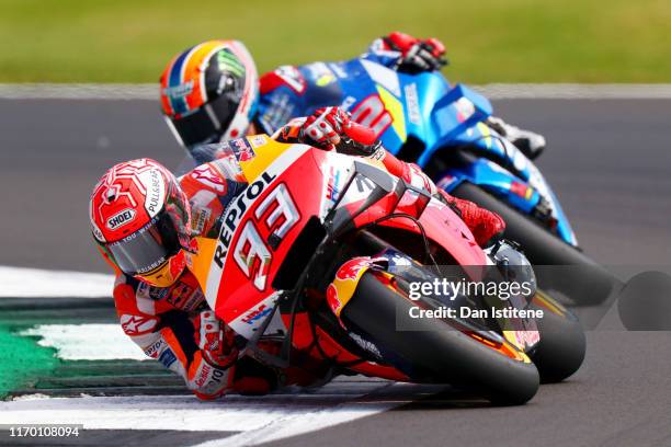 Marc Marquez of Spain and Repsol Honda leads Alex Rins of Spain and Team Suzuki Ecstar during the MotoGP of Great Britain at Silverstone Circuit on...