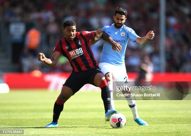 Jordon Ibe of AFC Bournemouth and Riyad Mahrez of Manchester City tussle for the ball during the Premier League match between AFC Bournemouth and...