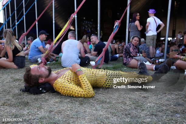 Festival goers takes respite from the sun during day three of Reading Festival 2019 at Richfield Avenue on August 25, 2019 in Reading, England.