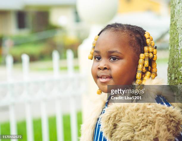 outdoor portrait of an adorable chubby 3 year old toddler with beads and braids - chubby girls stock pictures, royalty-free photos & images
