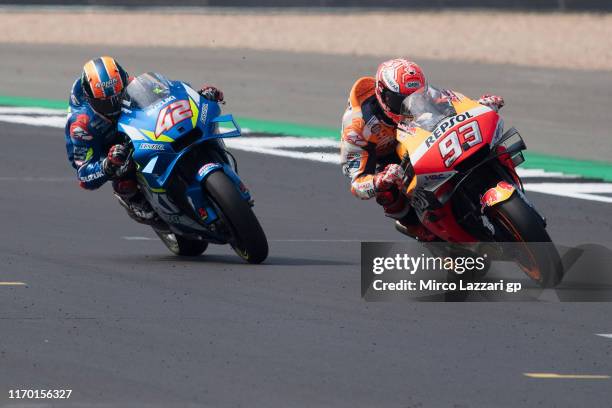 Marc Marquez of Spain and Repsol Honda Team leads Alex Rins of Spain and Team Suzuki ECSTAR during the MotoGP race during the MotoGp Of Great Britain...