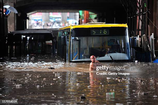 Vehicles are trapped in a flooded street after heavy rainfall on June 18, 2011 in Wuhan, Hubei Province of China. A heavy rainstorm hit Wuhan on...