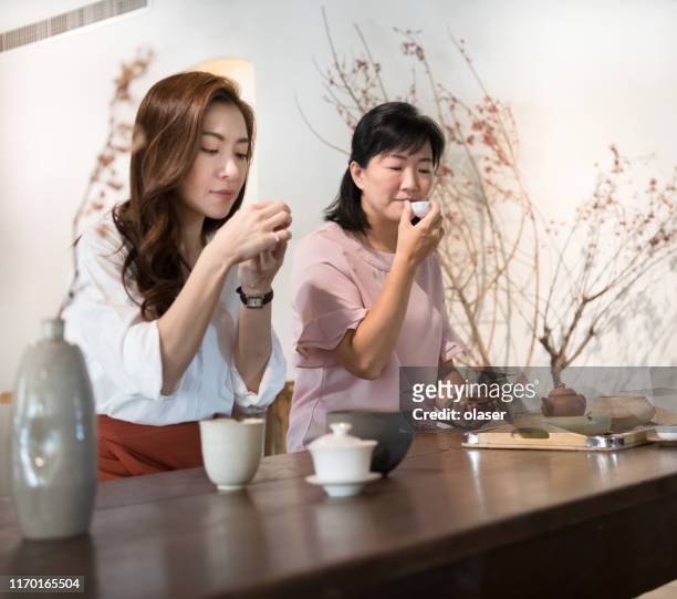 women enjoying tea in tea room - taipei tea stock pictures, royalty-free photos & images
