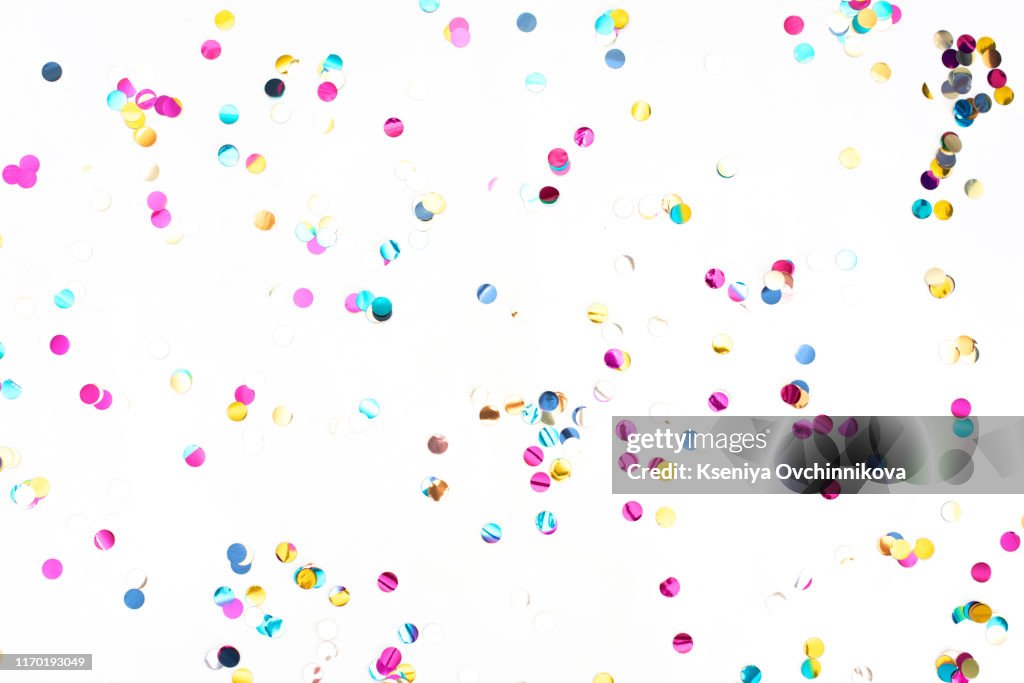 Colourful sparlking confetti on white background