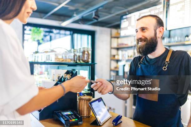 waiter accepting payment by card - debit cards credit cards accepted stock pictures, royalty-free photos & images