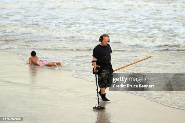 Visitor searches the beaches using a metal detector at Jones Beach on August 25, 2019 in Wantagh, New York.