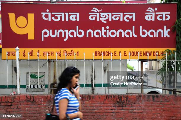 Girl walks past Punjab National Bank branch in New Delhi India on 21 September 2019