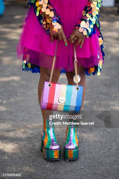 Guest is seen attending Afropunk Brooklyn wearing pink dress, colorful sequin jacket, rainbow pastel striped purse, metallic rainbow platform shoes,...