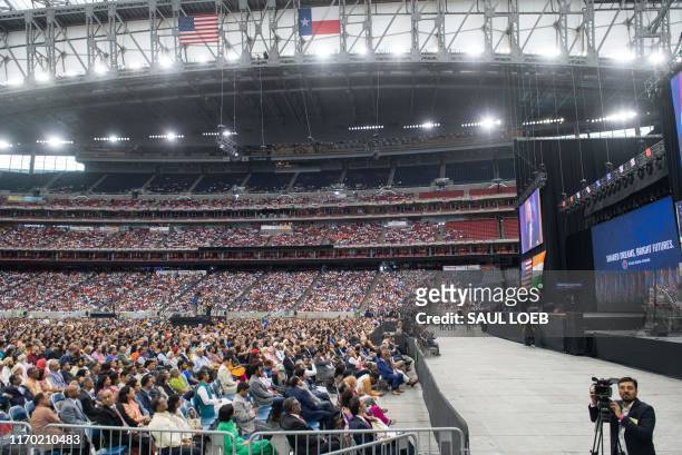 People listen as US President Donald Trump and Indian Prime Minister Narendra Modi attend "Howdy, Modi!" at NRG Stadium in Houston, Texas, September...