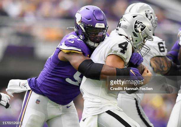 Everson Griffen of the Minnesota Vikings sacks quarterback Derek Carr of the Oakland Raiders during the second quarter of the game at U.S. Bank...