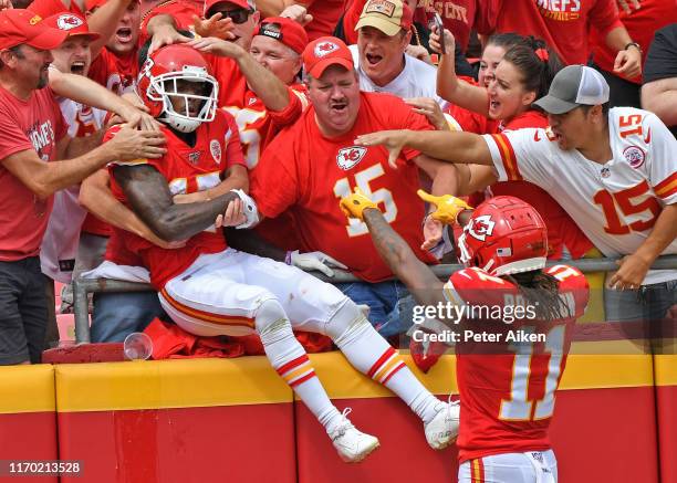 Wide receiver Mecole Hardman of the Kansas City Chiefs leaps into the stands after scoring a touchdown against the Baltimore Ravens during the first...